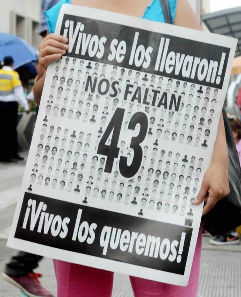 Selene Mendes , holds a sign in support of the 43 missing student during a march in Mexico City on May 26th 2015.